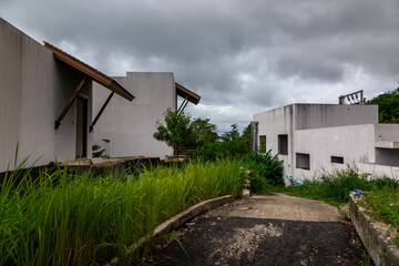 An abandoned hotel on the seashore. White buildings. Beautiful architecture. A cloudy day.