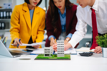 Professionals for a greener future. Showcasing renewable energy solutions with solar panels, wind turbines, and a model house.