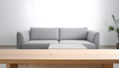 Fototapeta premium Inviting modern living room with plush gray sofa, minimalist coffee table, and natural wood foreground for product placement