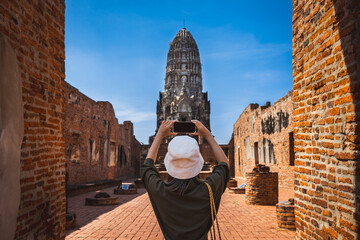 Traveler asian woman use mobile phone selfie in Wat Ratchaburana pagoda temple at Ayutthaya historical park Thailand Historical local travel holiday vacation Thai concept