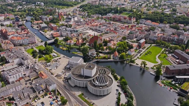 Drone establishing view of Bydgoszcz Poland city center with Opera Nova, river