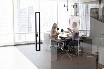 Two male and female business leaders discussing company management