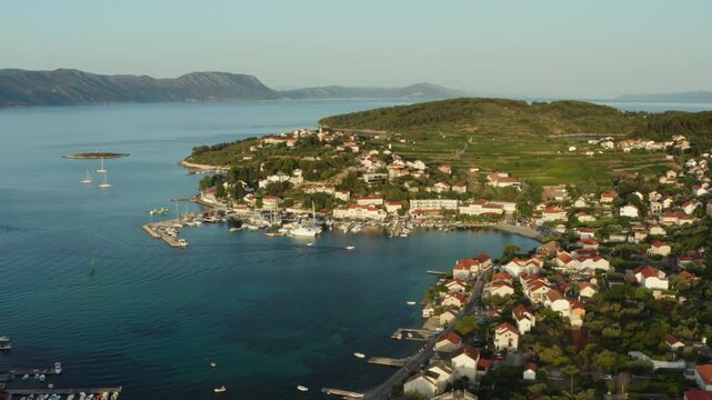 High aerial of Lumbarda's peninsula on Korcula island, Croatia. Landscape with green vineyards for Grk wine production, the coastline, and the Adriatic archipelago.