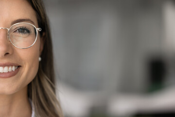 Happy beautiful young woman in stylish glasses half-face portrait