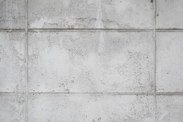 Grey textured concrete wall with grid lines