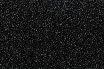 Abstract background of black kitchen sponge. View of texture surface of black kitchen scrubber sponge, background.