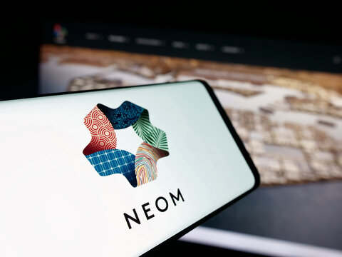 Stuttgart, Germany - 09-29-2025: Smartphone with logo of Saudi Arabian real estate project NEOM on screen in front of website. Focus on center-left of phone display.