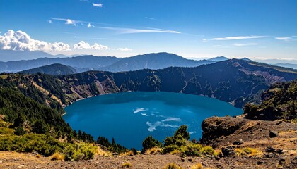 Discover the breathtaking turquoise Crater Lake surrounded by dramatic mountain peaks under a bright blue sky, ideal for travel, adventure, and nature photography projects