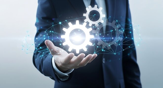 Businessman holding glowing digital gears in his hand representing innovation technology and the interconnectedness of business processes in a modern digital world