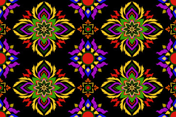 Vibrant seamless mandala floral pattern in red, yellow, purple, and green on black background, ideal for boho textiles, festive fashion, and modern home decor.