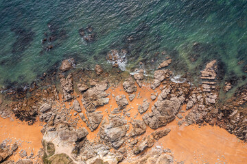 Beautiful ocean landscape from a drone. Rocks, turquoise water, and beach. Vacation travel.