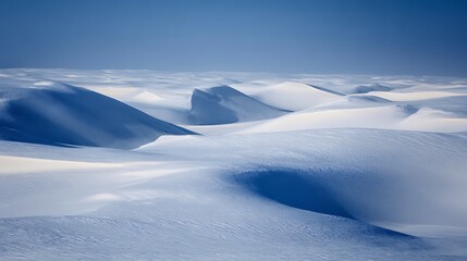 Beautiful snow dunes landscape under the clear sky in winter season