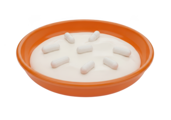 White pills floating in a bowl of white powder isolated on transparent background