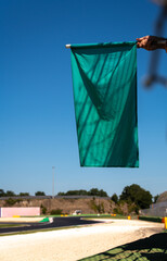 Green flag in racetrack motorsport, end of caution sign