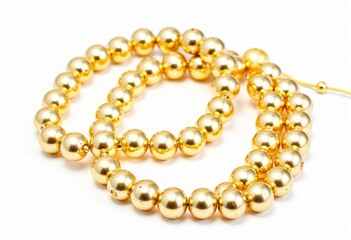 Obraz premium Elegant Gold Bead Necklace Shining Against a White Background, Featuring a Luxurious and Intricate Design with Perfectly Round Golden Beads