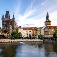 Obraz premium A picturesque cityscape next to a river with buildings and towers