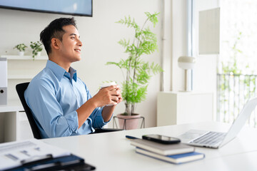 Fototapeta premium Happy smiling professional business man company employee, young male worker manager, businessman working on laptop computer technology looking aside at copy space working in office.
