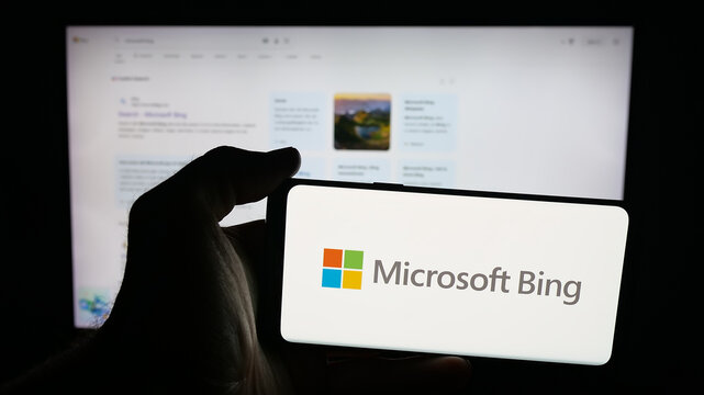 Stuttgart, Germany - 10-01-2025: Person holding mobile phone with logo of Internet search engine Microsoft Bing on screen in front of web page. Focus on phone display.