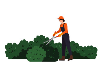 A woman in overalls and hat is trimming a hedge with large shears in a garden setting.