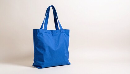 Plain blue tote bag on neutral background.