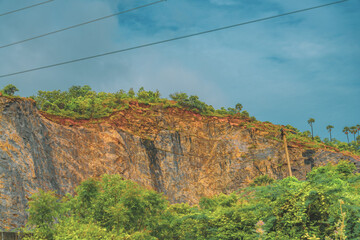 A mountain with a green forest on it