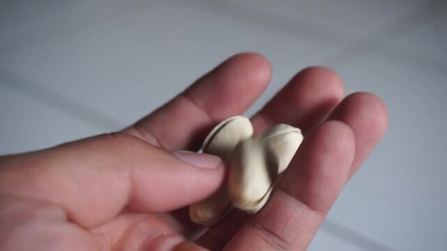 Pistachio nuts in a man's hand