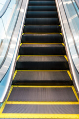 Premium escalator with metal steps and yellow safety lines modern architecture for transit