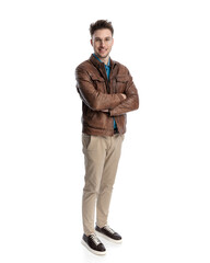 happy casual man in brown leather jacket crossing arms and smiling