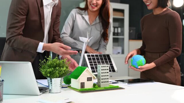 Business people having consultation about wind energy at company office. Business team discussing about windmill and alternative green enery. Executive meeting