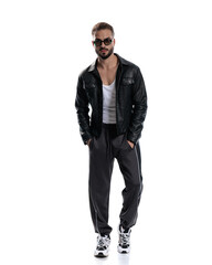 Fototapeta premium cool fashion man in black leather jacket holding hands in pockets