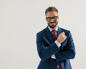 happy elegant businessman closing eyes while crossing arms and smiling