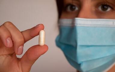 Woman Wearing Face Mask Holding Tablet, Medical and Safety Concept