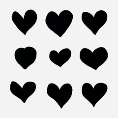 Collection of nine hand drawn black heart shapes on a white background.