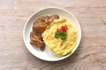 fried creamy egg omelet topping plain rice dressing potato and carrot in Japanese curry on plate 