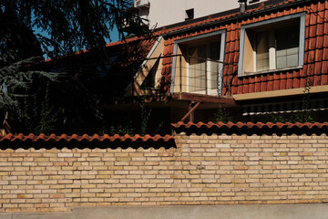 Residential house with a brick fence and red tiled roof in Belgrade, Serbia