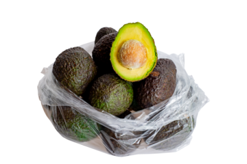 Fresh ripe avocados in a plastic bag with one cut in half showing seed and creamy flesh on transparent background. Healthy tropical fruit rich in nutrients, ideal for diet, cooking, or organic food 