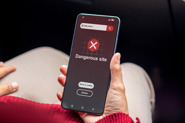 A woman visit a website indicates malware, phishing or deceptive practices on her smartphone....