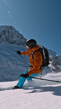 Off Piste Skier Running Down. Super Slow Motion, 1000 fps. Skiing on Free Ride off Piste Slope in European Dolomites Mountains, Italy. Speed Ramp Effect. Vertical Aspect Ratio.