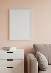 Minimalist living room interior with a blank picture frame on a peach wall above a white dresser and a grey sofa