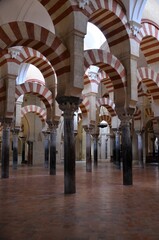 Cordoba, Spain 03.27.2019: Ceiling with double arches of white stone and red brick at the Prayer...