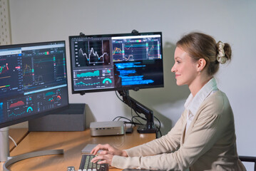 Focused professional analyzes financial data multiple screens modern office environment. atmosphere is one of concentration and productivity, showcasing advanced technology and data visualization