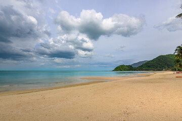Beach with a cloudy sky in the background