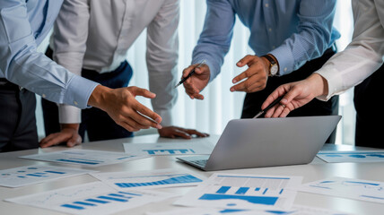 Business people analyzing company financial report working with documents and laptop in the office, discussing project and brainstorming ideas