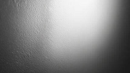 A close-up of a textured surface featuring droplets of moisture, creating a subtle gradient effect from light to dark.