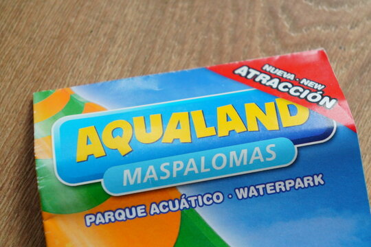 Close-up of Aqualand Maspalomas brochure showcasing its waterpark attractions and new features in bold colorful design