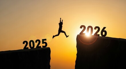 Silhouette of man jumping from 2025 to 2026 on sunset background
