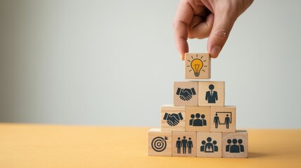 Hand putting wooden block on the stack of wooden blocks with light bulb icon, business strategy and creative idea concept