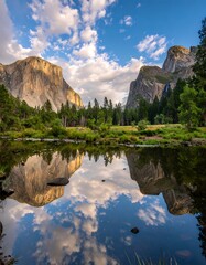 Naklejka premium Majestic mountains reflected in serene water under a bright blue sky