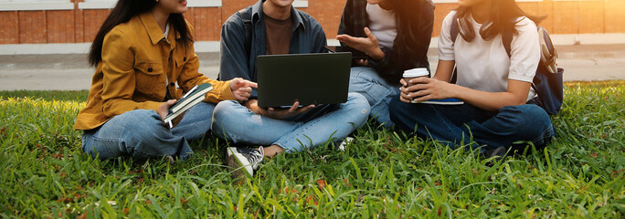 Happy students walking together on university campus, chatting and laughing outdoors after classes