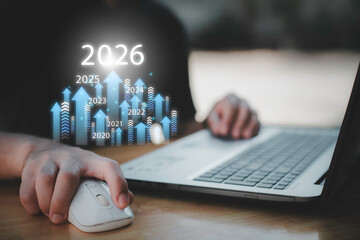 Businessman drawing digital growth arrows and bar graph with 2026 target. Futuristic concept for business goals, technology strategy, data-driven planning, success and innovation.